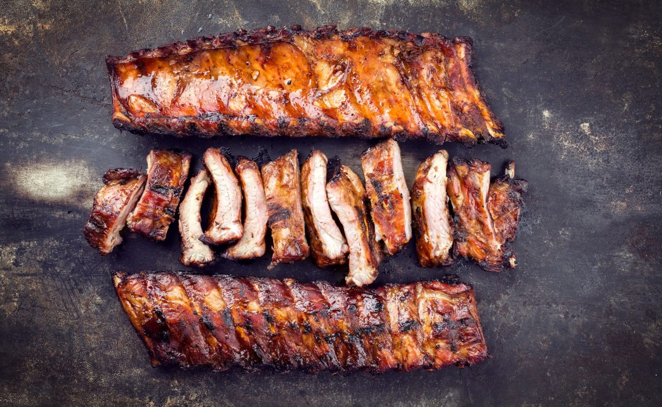 Barbecue Pork Spare Ribs as top view on an old rusty metal sheet